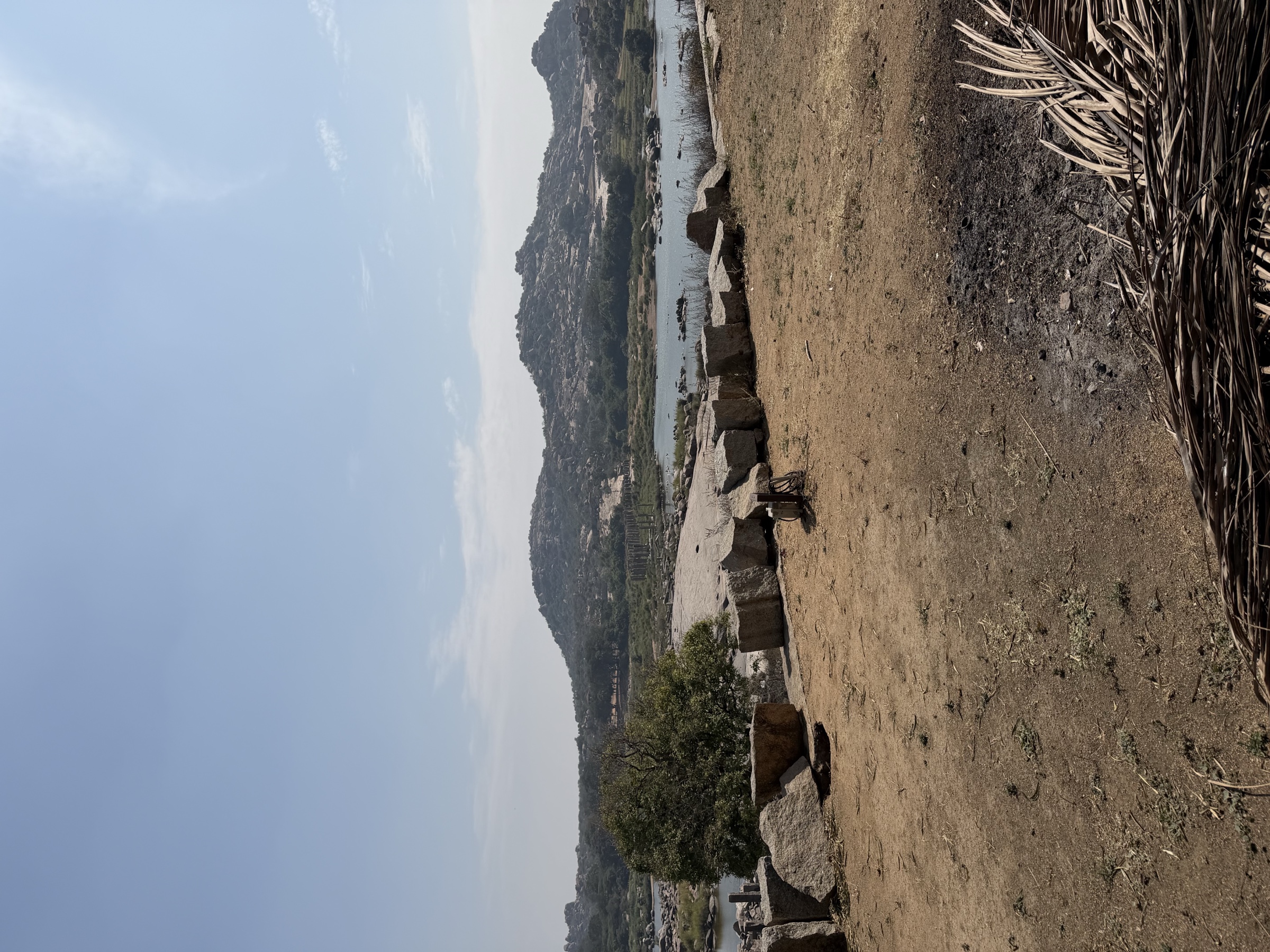 Wide view of the old bridge remains between Rishimukha and the Hampi landscape